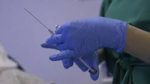syringe in the hands of a doctor